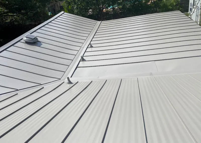 Solar attic fan installed on a metal roof for Roof Ventilation in Rye Brook